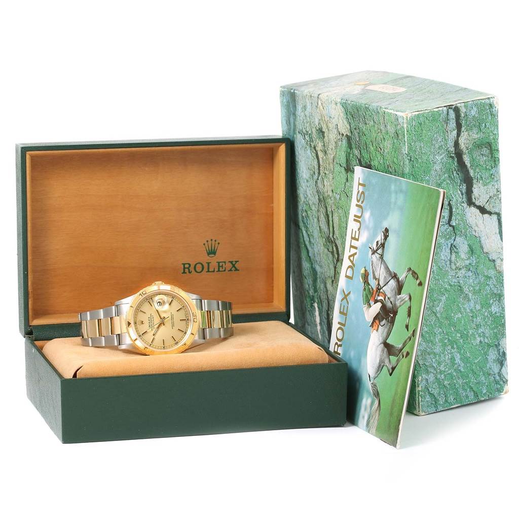 The angle shows the Rolex Turn-o-Graph 16263 Men's Steel and Gold (two tone) Champagne Dial 16263 Men's Steel and Gold (two tone) Champagne Dial watch lying flat in its box next to a manual and the outer packaging.