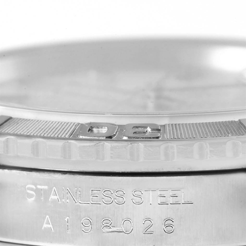 The image shows a macro view of the case and bezel of a Rolex Turn-o-Graph 16264 Men's Stainless Steel Silver Dial 16264 Men's Stainless Steel Silver Dial, highlighting the "Stainless Steel" material and serial number.