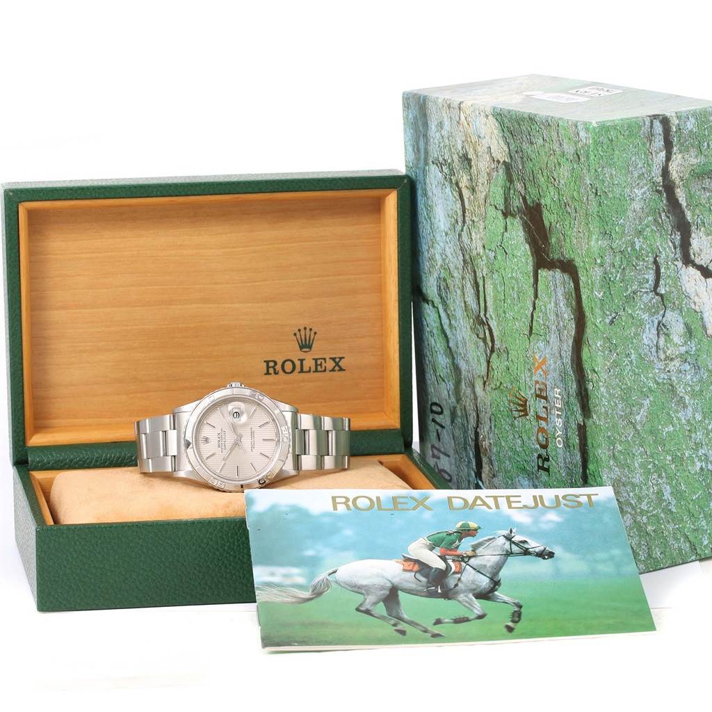 The Rolex Turn-o-Graph 16264 Men's Stainless Steel Silver Dial 16264 Men's Stainless Steel Silver Dial watch is displayed at a front angle in an open box with accompanying accessories and booklet visible.
