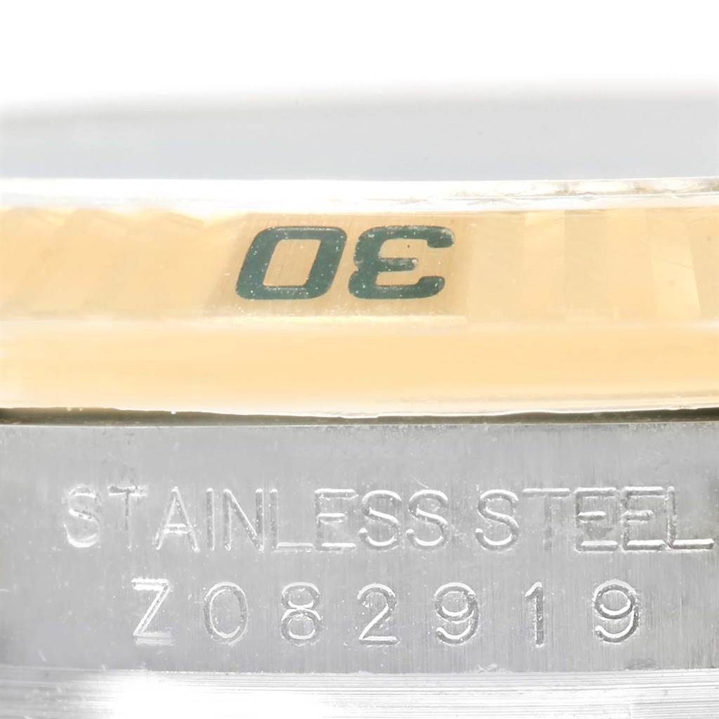 The image shows a close-up of the bezel and the stainless steel casing with the serial number of the Rolex Turn-o-Graph 116263 Men's Stainless Steel White Dial 116263 Men's Stainless Steel White Dial model.