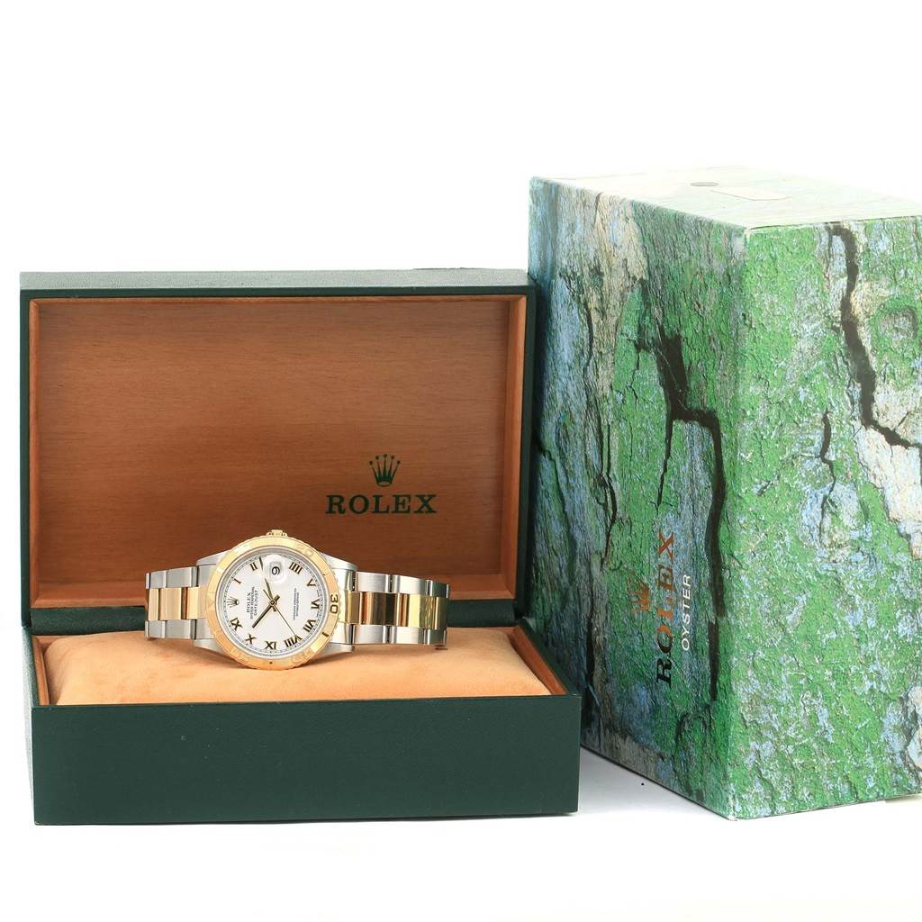 The Rolex Turn-o-Graph 16263 Men's Steel and Gold (two tone) White Dial 16263 Men's Steel and Gold (two tone) White Dial watch is shown from the front inside its open green and wood box, next to a textured green outer box.