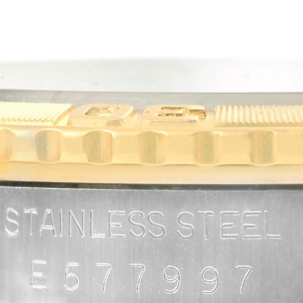 The image shows a close-up of the engraved stainless steel side and part of the gold bezel of a Rolex Turn-o-Graph 16263 Men
s Steel and Gold (two tone) White Dial 16263 Men
s Steel and Gold (two tone) White Dial watch.