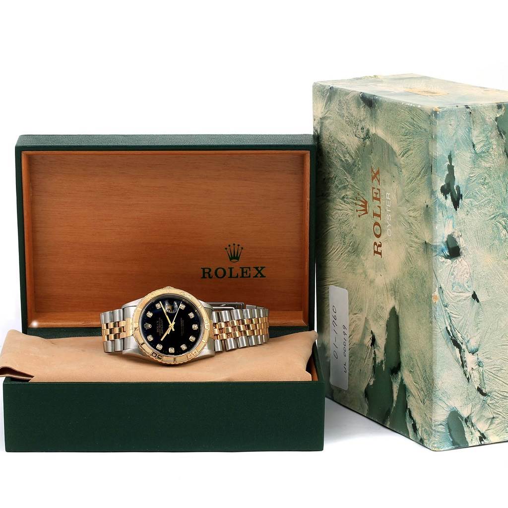 The Rolex Turn-o-Graph 16263 Men
s Steel and Gold (two tone) Black Dial 16263 Men
s Steel and Gold (two tone) Black Dial watch is shown in its display box, alongside the original outer packaging.