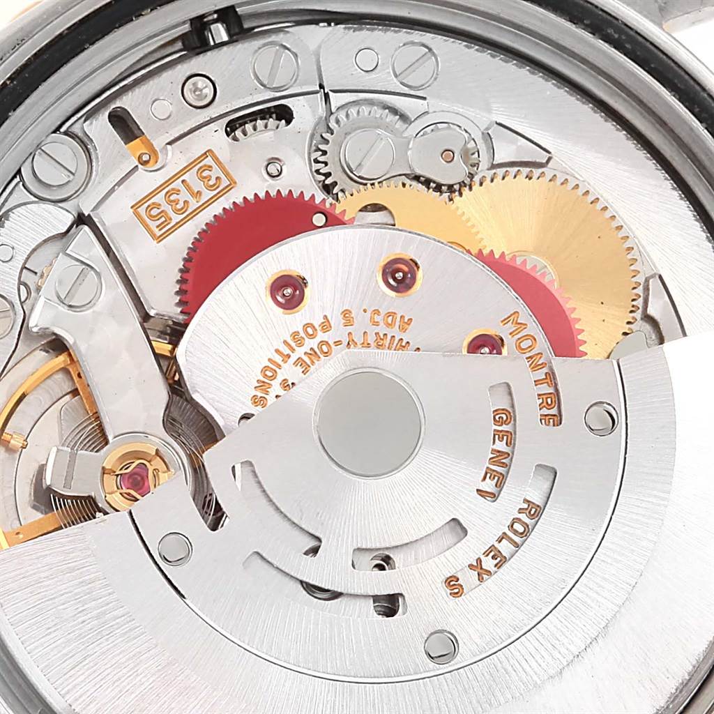 This image shows the movement mechanism of a Rolex Turn-o-Graph 16263 Men
s Steel and Gold (two tone) Black Dial 16263 Men
s Steel and Gold (two tone) Black Dial watch, including gears and the rotor engraved with "ROLEX" and "GENEVA".