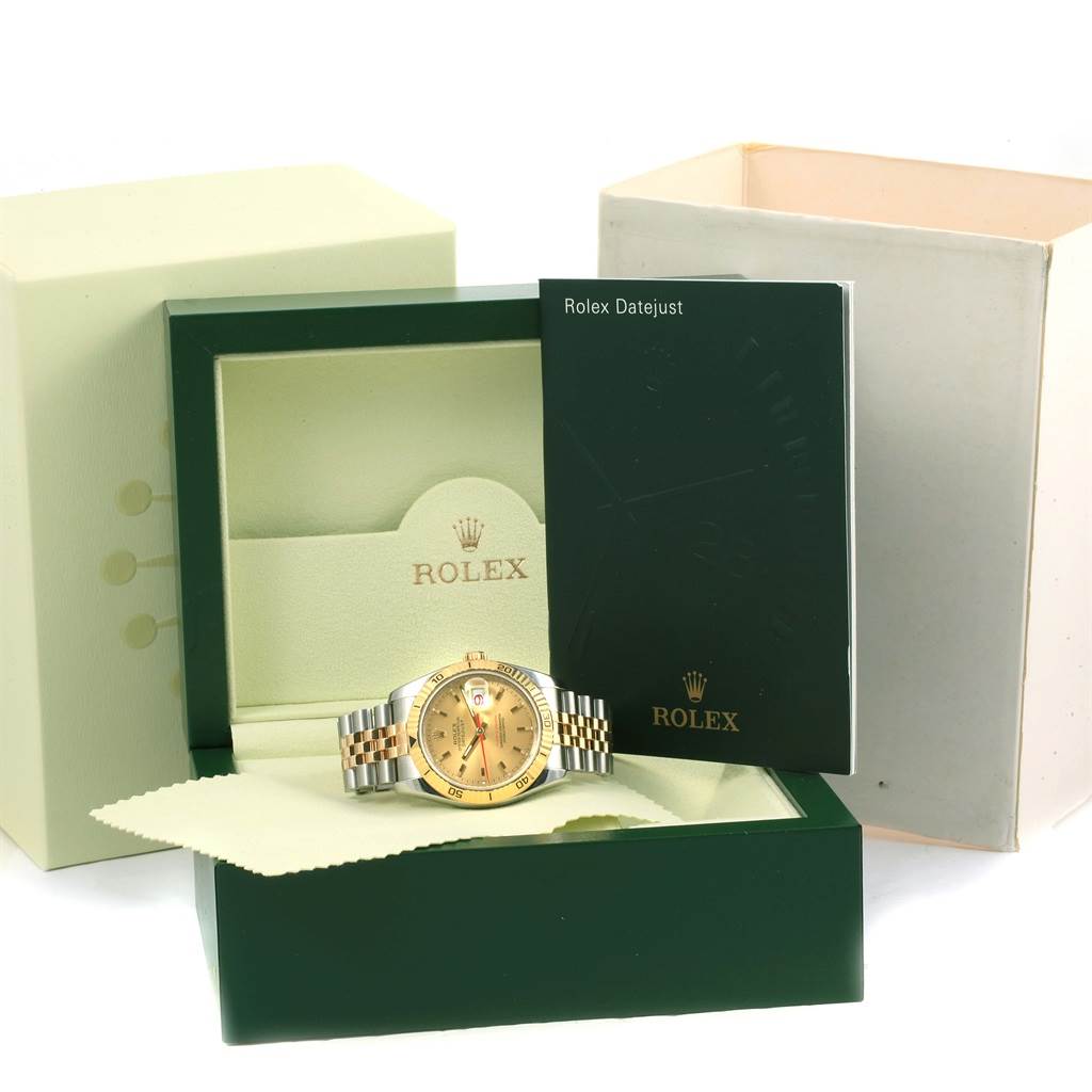 The Rolex Turn-o-Graph 116263 Men's Stainless Steel Champagne Dial 116263 Men's Stainless Steel Champagne Dial watch is shown at a straight angle inside its open box, alongside the box lid and user manual.