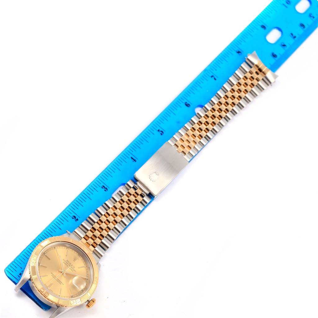 The image shows a Rolex Turn-o-Graph 16263 Men
s Steel and Gold (two tone) Champagne Dial 16263 Men
s Steel and Gold (two tone) Champagne Dial watch at an overhead angle, highlighting the face and bracelet alongside a ruler for scale.