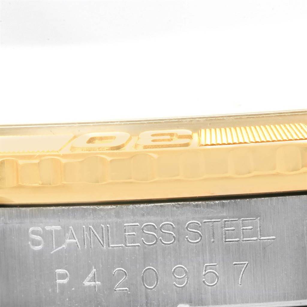 Close-up of a Rolex Turn-o-Graph 16263 Men
s Steel and Gold (two tone) Champagne Dial 16263 Men
s Steel and Gold (two tone) Champagne Dial watch showing the gold bezel and part of the stainless steel case with a visible serial number.