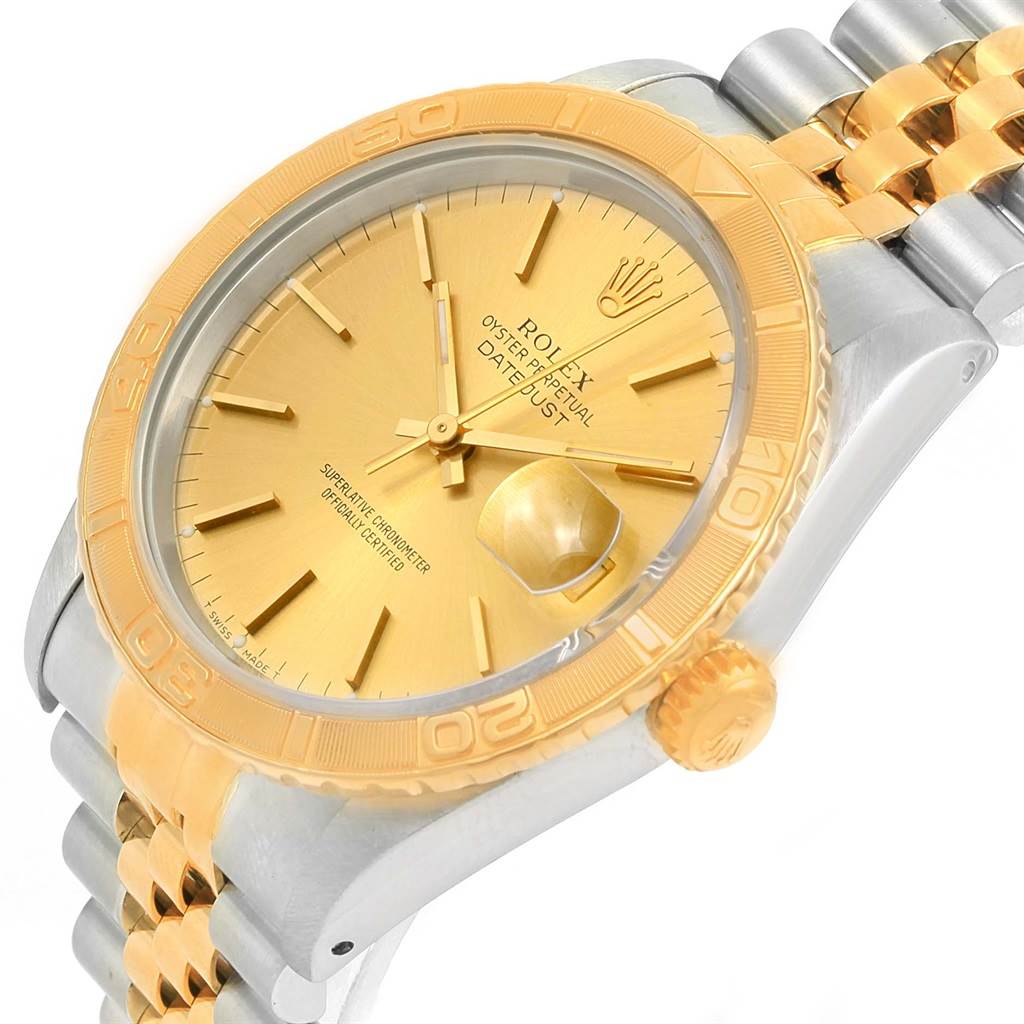 The image shows a close-up angle of the Rolex Turn-o-Graph 16263 Men
s Steel and Gold (two tone) Champagne Dial 16263 Men
s Steel and Gold (two tone) Champagne Dial watch, featuring the crown, bezel, and a portion of the bracelet.