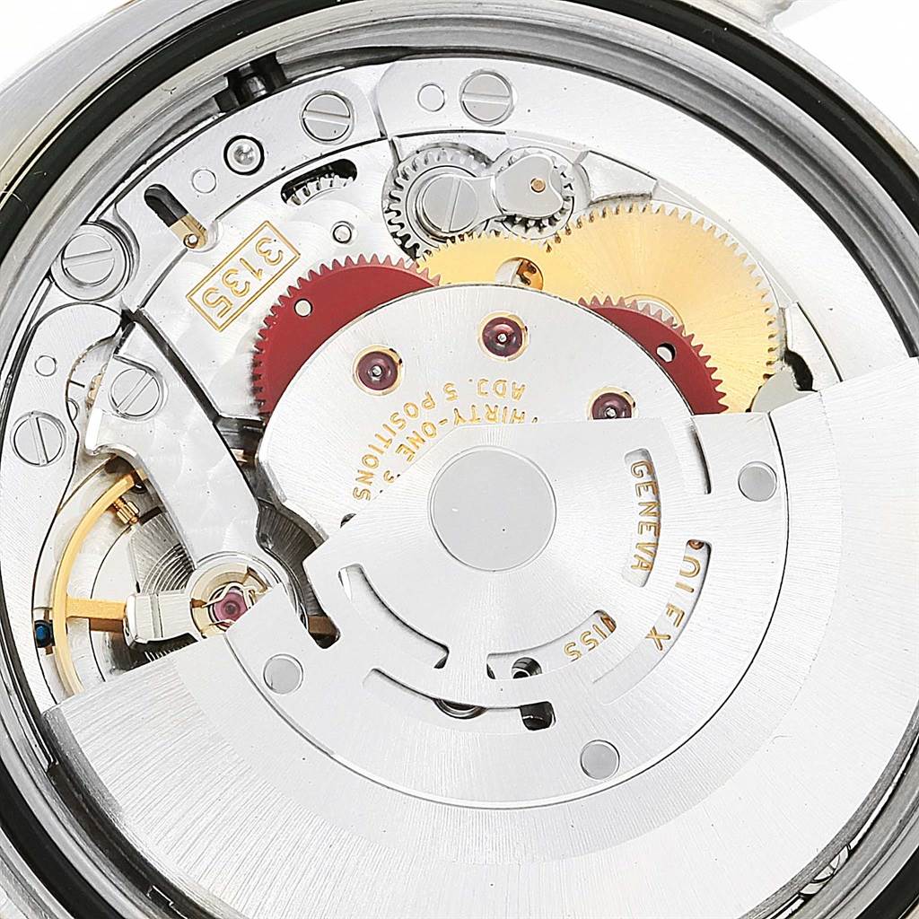 The image depicts the movement mechanism of a Rolex Turn-o-Graph 116263 Men's Stainless Steel White Dial 116263 Men's Stainless Steel White Dial watch from a close-up, focusing on gears and other internal components.