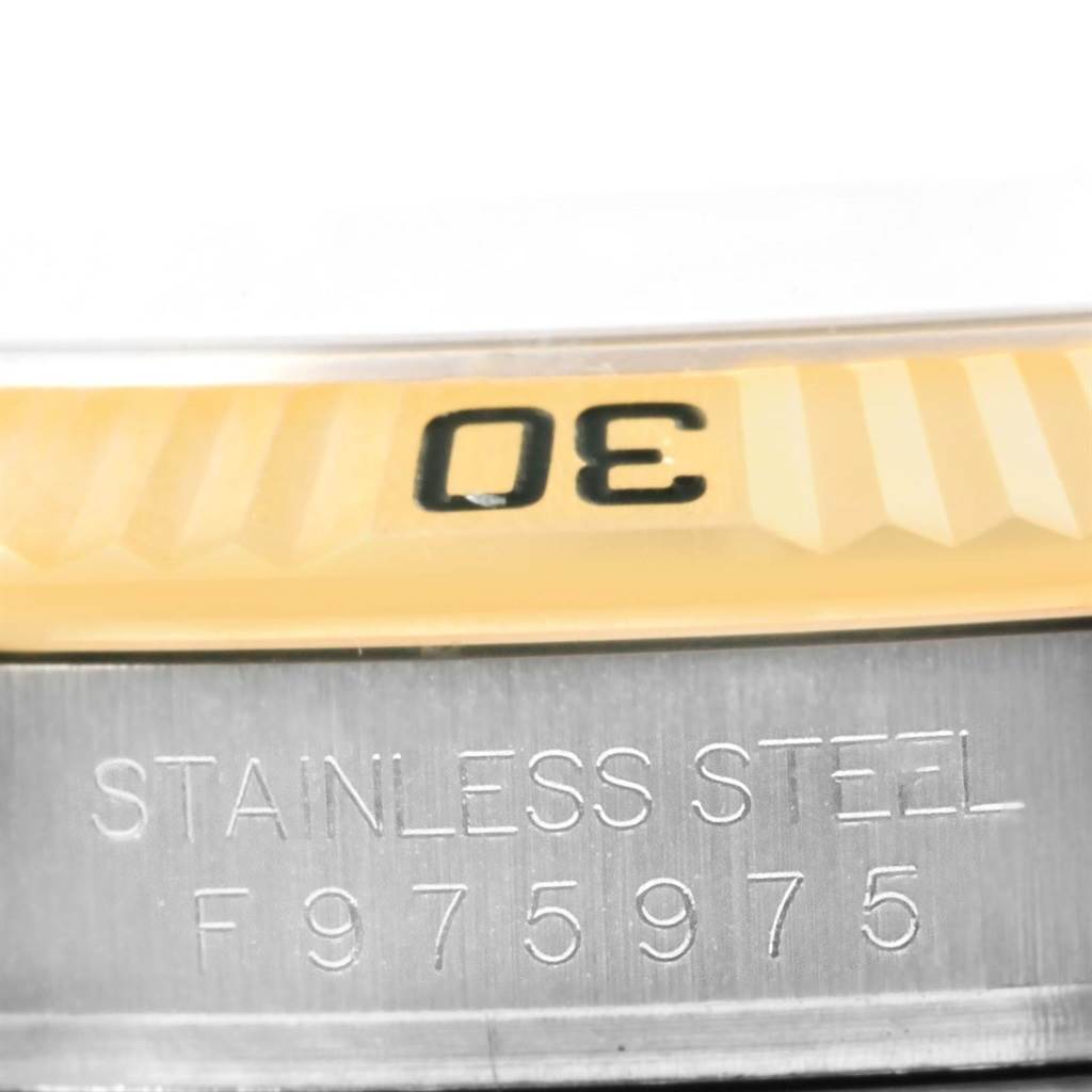 This image shows a close-up of the bezel and serial number area of a Rolex Turn-o-Graph 116263 Men's Stainless Steel White Dial 116263 Men's Stainless Steel White Dial watch.