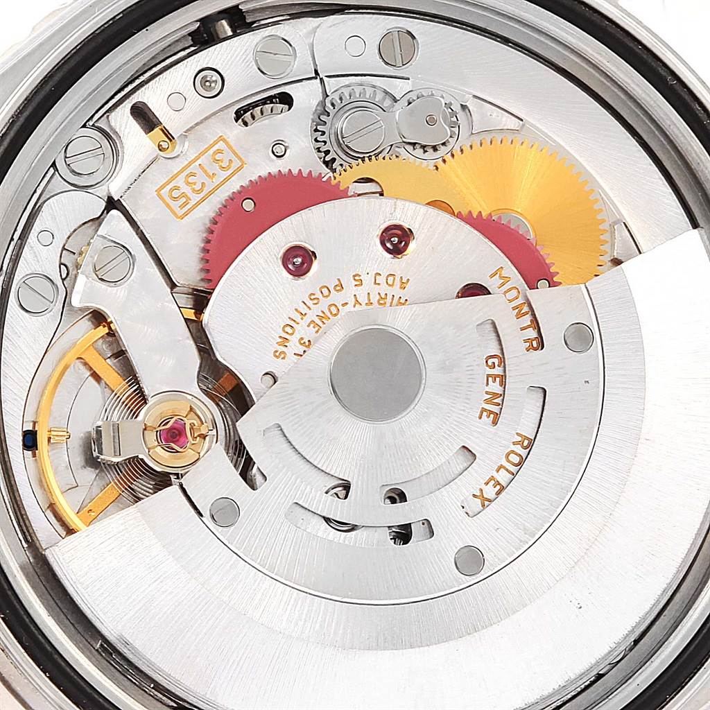 The image shows the intricate internal mechanism of the Rolex Turn-o-Graph 16264 Men's Stainless Steel Blue Dial 16264 Men's Stainless Steel Blue Dial watch with visible gears and rotor.