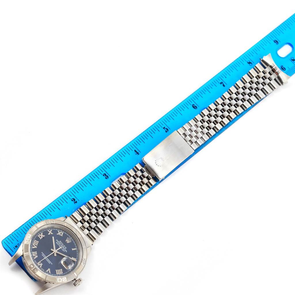 The image shows a Rolex Turn-o-Graph 16264 Men's Stainless Steel Blue Dial 16264 Men's Stainless Steel Blue Dial watch laid flat on a ruler, displaying the face, bezel, and bracelet.