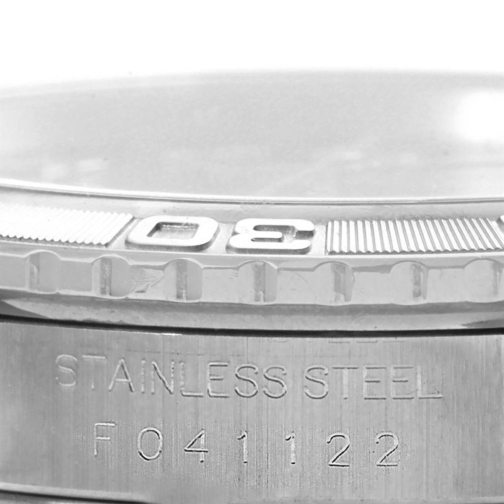 This image shows a close-up of the bezel and engraved serial number on the stainless steel case of a Rolex Turn-o-Graph 16264 Men's Stainless Steel Blue Dial 16264 Men's Stainless Steel Blue Dial watch.