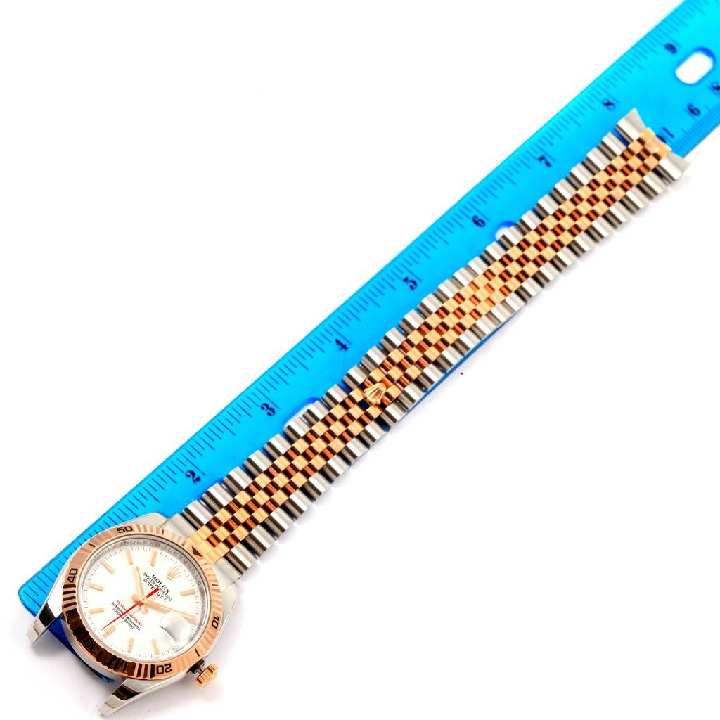 The image shows a Rolex Turn-o-Graph 116261 Men's Stainless Steel White Dial 116261 Men's Stainless Steel White Dial watch laid flat next to a ruler, displaying its face and bracelet.