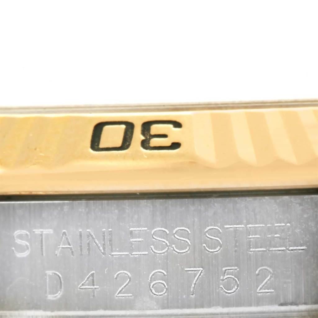 This close-up image of a Rolex Turn-o-Graph 116263 Men
s Stainless Steel Champagne Dial 116263 Men
s Stainless Steel Champagne Dial shows the bezel and a part of the case with the "STAINLESS STEEL" engraving and serial number.