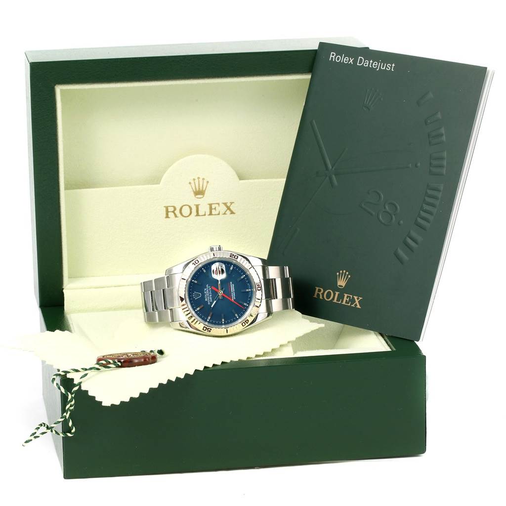 The Rolex Turn-o-Graph 116264 Men's Stainless Steel Blue Dial 116264 Men's Stainless Steel Blue Dial watch is pictured inside its box with the manual visible, showing a front angle.