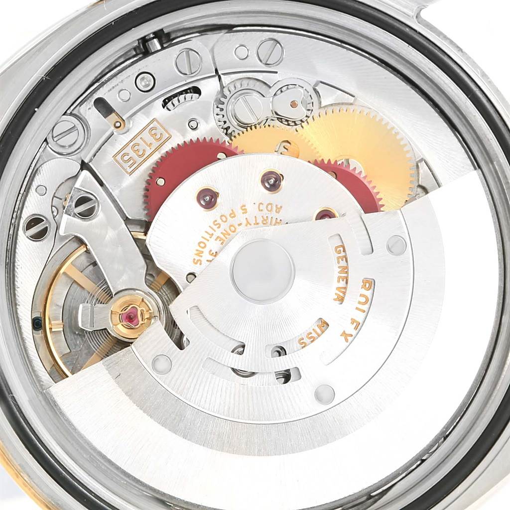 This image displays the internal mechanical movement of a Rolex Turn-o-Graph 116263 Men's Steel and Gold (two tone) Grey Dial 116263 Men's Steel and Gold (two tone) Grey Dial model, showcasing gears, screws, and the rotor.