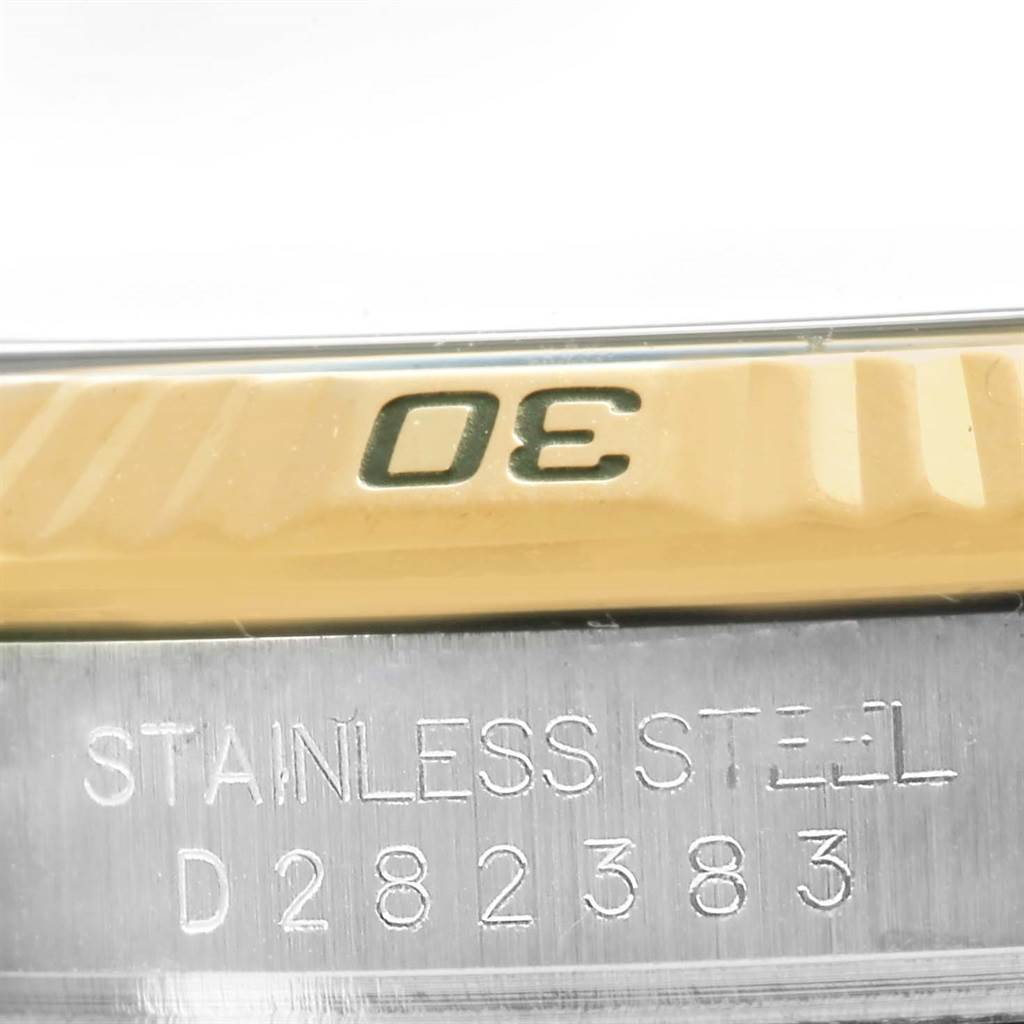 The image shows a close-up of the engraved bezel and serial number on the case of a Rolex Turn-o-Graph 116263 Men's Steel and Gold (two tone) Grey Dial 116263 Men's Steel and Gold (two tone) Grey Dial watch.