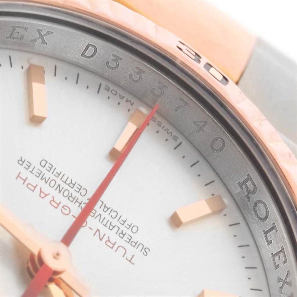 The image shows a close-up of the dial and bezel of a Rolex Turn-o-Graph 116261 Men's Stainless Steel Silver Dial 116261 Men's Stainless Steel Silver Dial watch, displaying part of the brand name and an indicator hand.