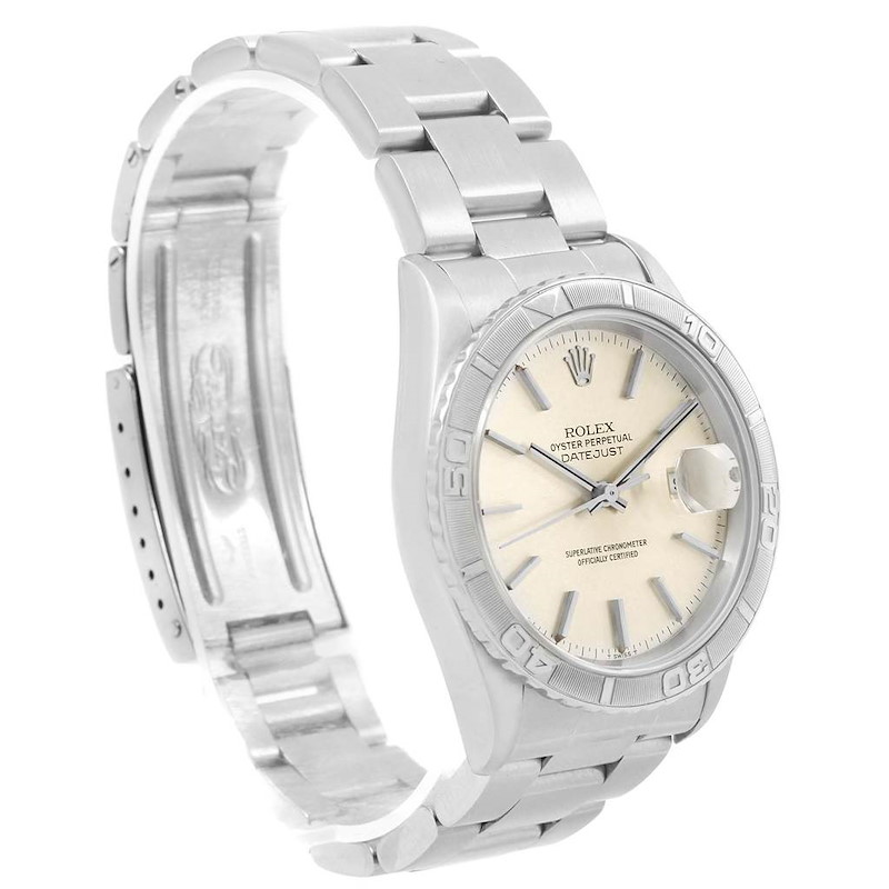 The image shows a Rolex Turn-o-Graph watch featuring the face, bezel, and part of the metal bracelet from a side angle.