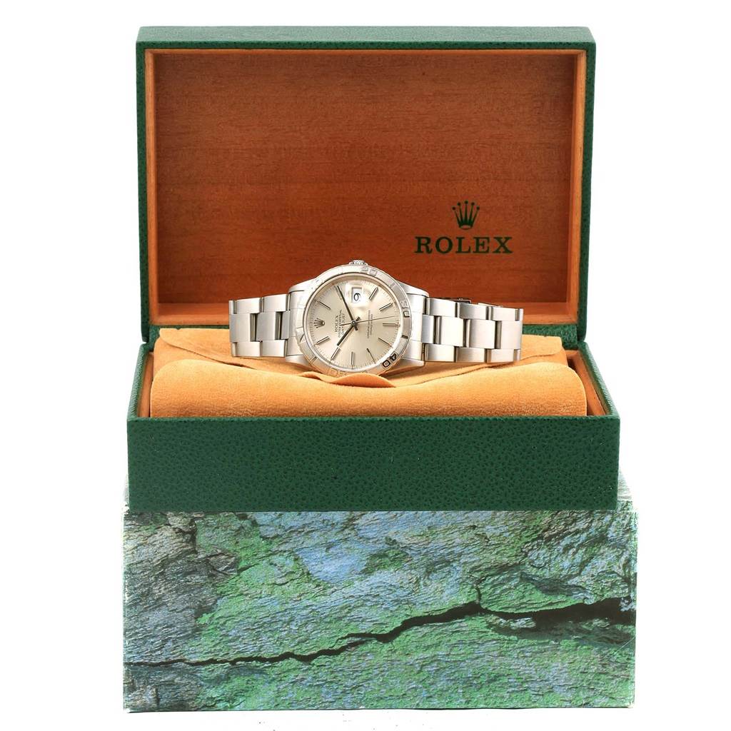 The Rolex Turn-o-Graph 16264 Men's Stainless Steel Silver Dial 16264 Men's Stainless Steel Silver Dial model watch is displayed front-on inside an open green box with an orange cushion.