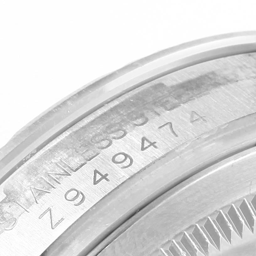 The image shows a close-up of the serial number and part of the bezel of a Rolex Turn-o-Graph 116264 Men
s Stainless Steel White Dial 116264 Men
s Stainless Steel White Dial watch.