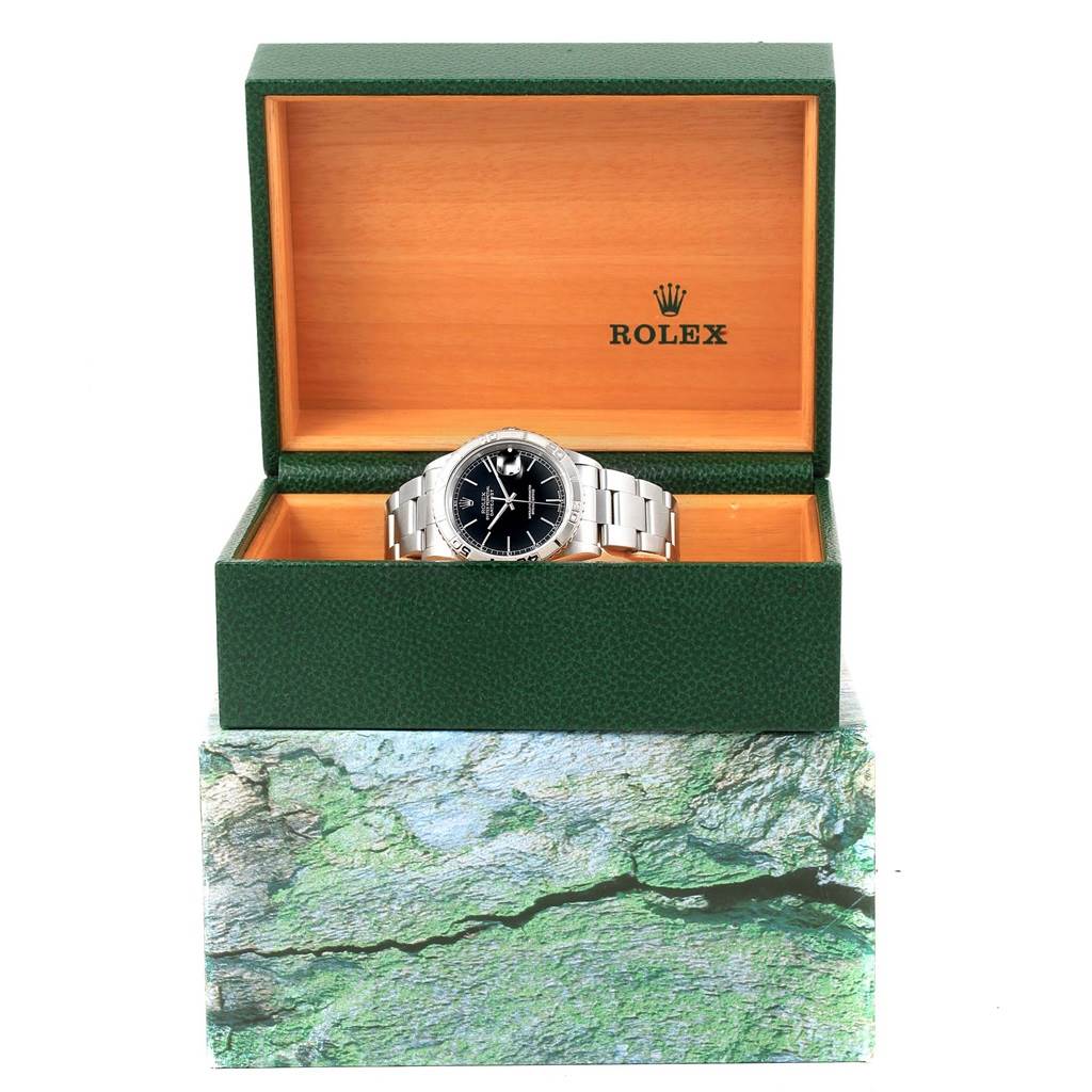 The Rolex Turn-o-Graph 16264 Men's Stainless Steel Black Dial 16264 Men's Stainless Steel Black Dial watch is set centrally in an open green box with a wooden interior, viewed from a frontal angle.