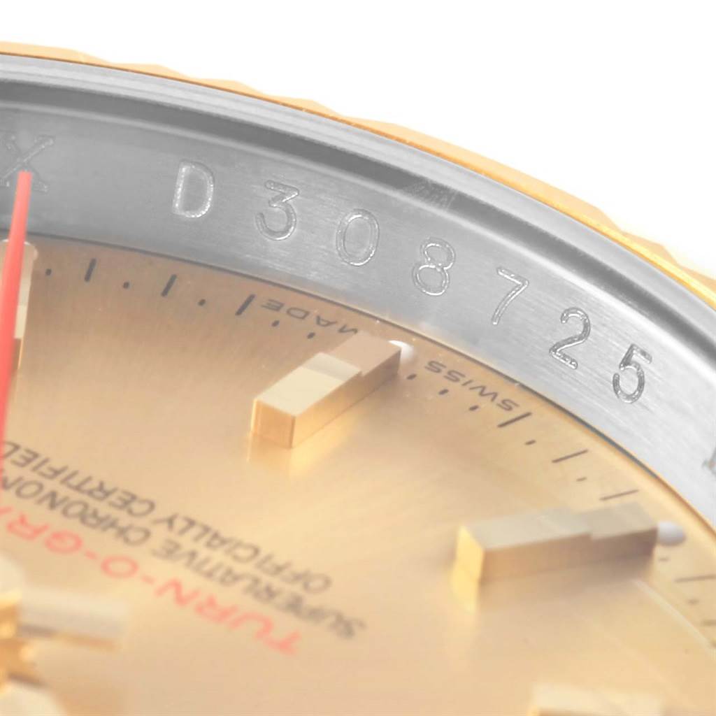 This close-up image of a Rolex Turn-o-Graph 116263 Men's Stainless Steel Champagne Dial 116263 Men's Stainless Steel Champagne Dial watch shows the dial, hour markers, and part of the case with the serial number.
