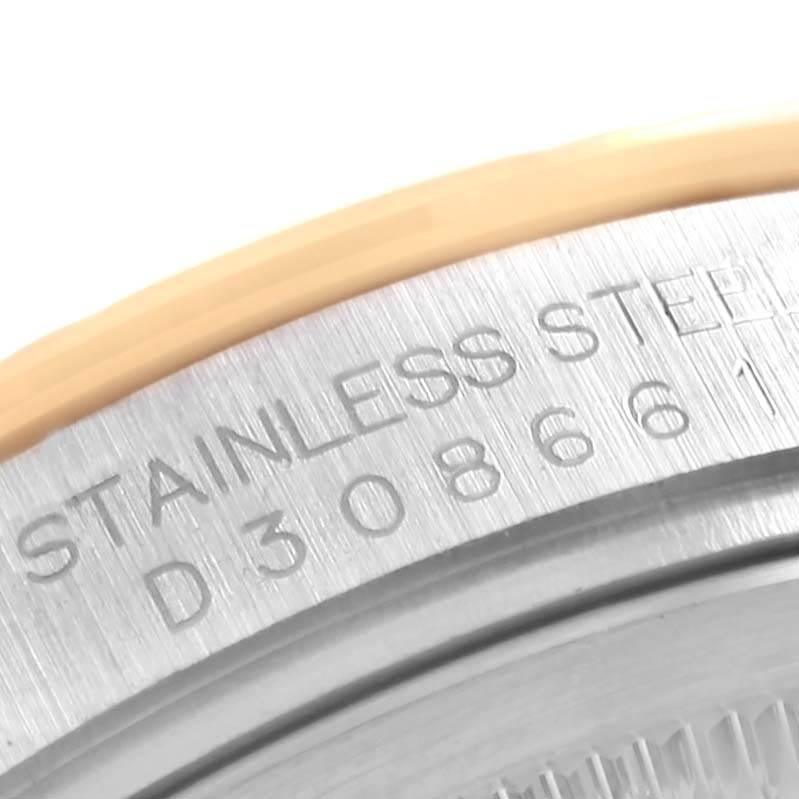 This image shows a close-up of the stainless steel case back and part of the bezel of the Rolex Turn-o-Graph 116263 Men's Steel and Gold (two tone) Grey Dial 116263 Men's Steel and Gold (two tone) Grey Dial watch.