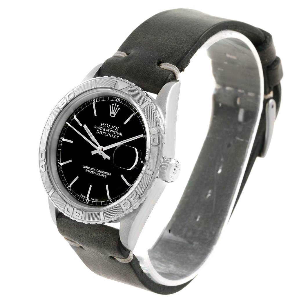 The Rolex Turn-o-Graph 16264 Men's Stainless Steel Black Dial 16264 Men's Stainless Steel Black Dial watch is shown at a front-side angle, highlighting its black dial, bezel, and leather strap.