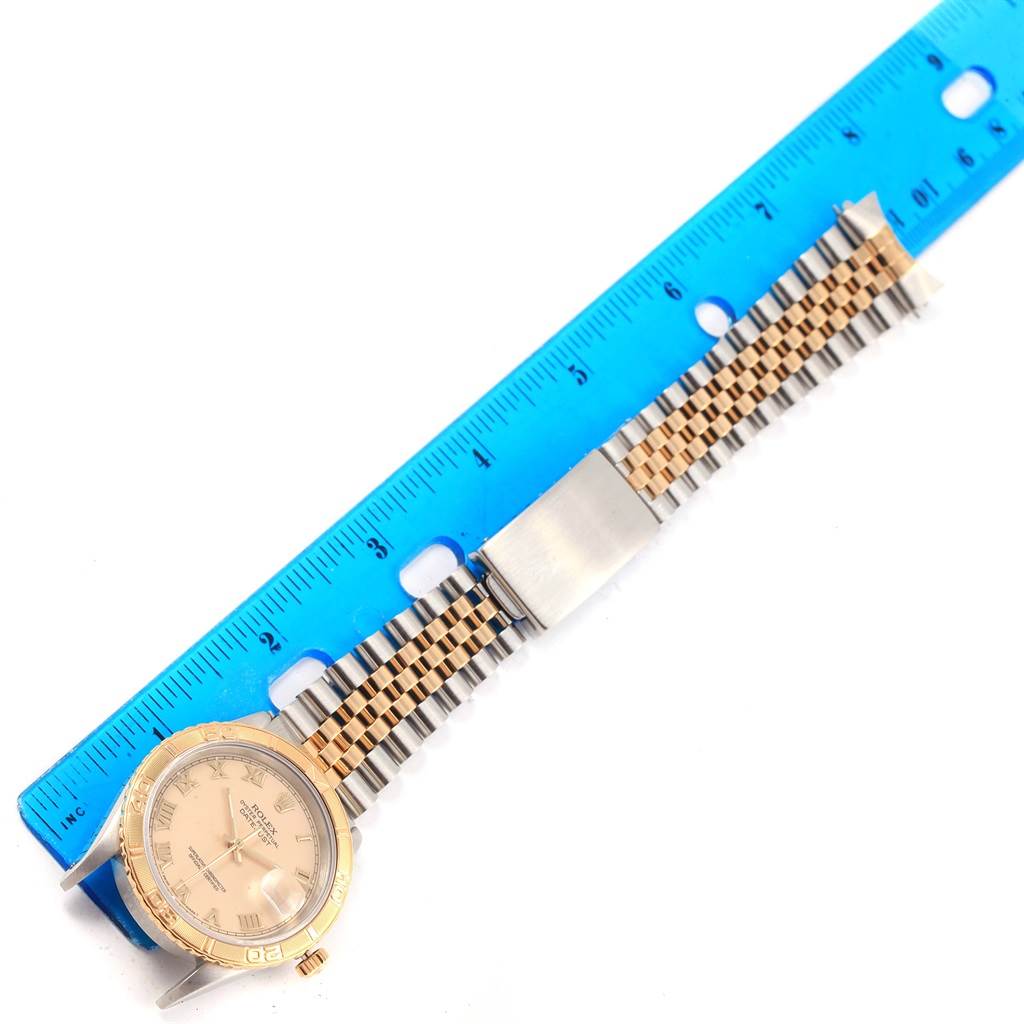 The Rolex Turn-o-Graph 16263 Men
s Steel and Gold (two tone) Beige Dial 16263 Men
s Steel and Gold (two tone) Beige Dial watch is shown from a top view, highlighting the face, bezel, and bracelet beside a ruler for size reference.