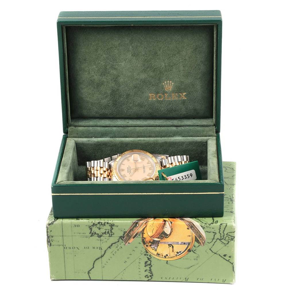 The Rolex Turn-o-Graph 16263 Men
s Steel and Gold (two tone) Beige Dial 16263 Men
s Steel and Gold (two tone) Beige Dial watch is displayed in a partially open green box, showcasing its dial and bracelet.