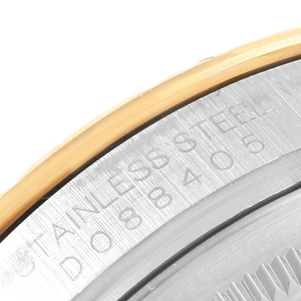 This close-up shows the case back and edge of the bezel of the Rolex Turn-o-Graph 116263 Men's Steel and Gold (two tone) Grey Dial 116263 Men's Steel and Gold (two tone) Grey Dial, revealing engraved text and a steel finish.