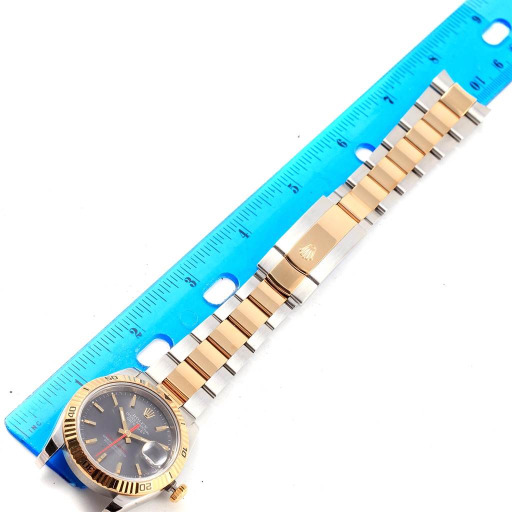The image shows a Rolex Turn-o-Graph 116263 Men's Steel and Gold (two tone) Grey Dial 116263 Men's Steel and Gold (two tone) Grey Dial watch laid flat next to a ruler, displaying its face, bezel, and bracelet.