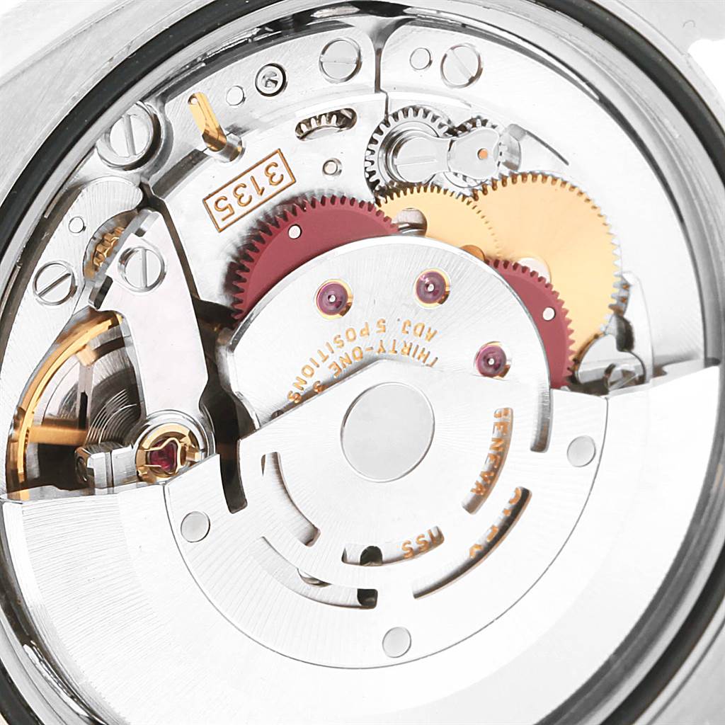 The image shows a close-up view of the internal mechanism of a Rolex Turn-o-Graph 116261 Men
s Stainless Steel Silver Dial 116261 Men
s Stainless Steel Silver Dial watch, highlighting its gears, rotor, and intricate parts.