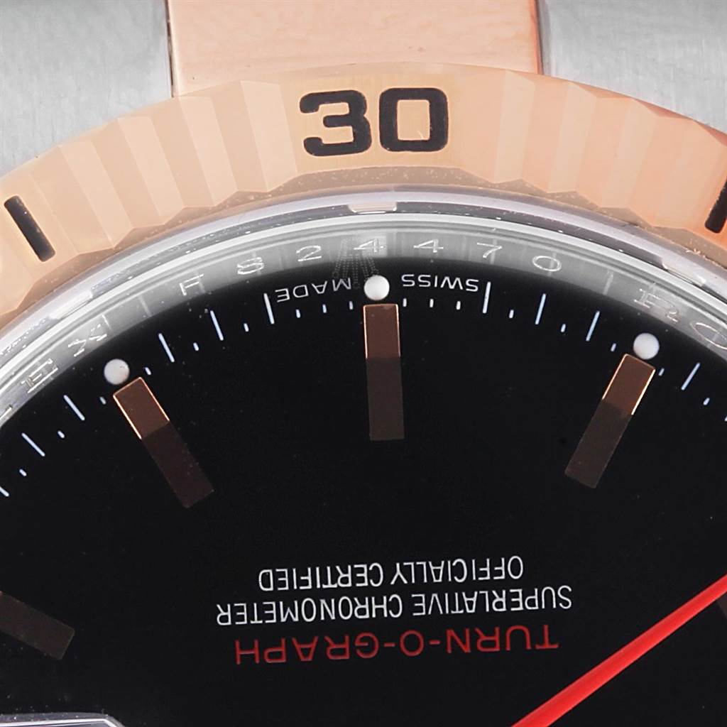 The image shows a close-up of the bezel, dial, and part of the bracelet of a Rolex Turn-o-Graph 116261 Men's Stainless Steel Black Dial 116261 Men's Stainless Steel Black Dial watch.