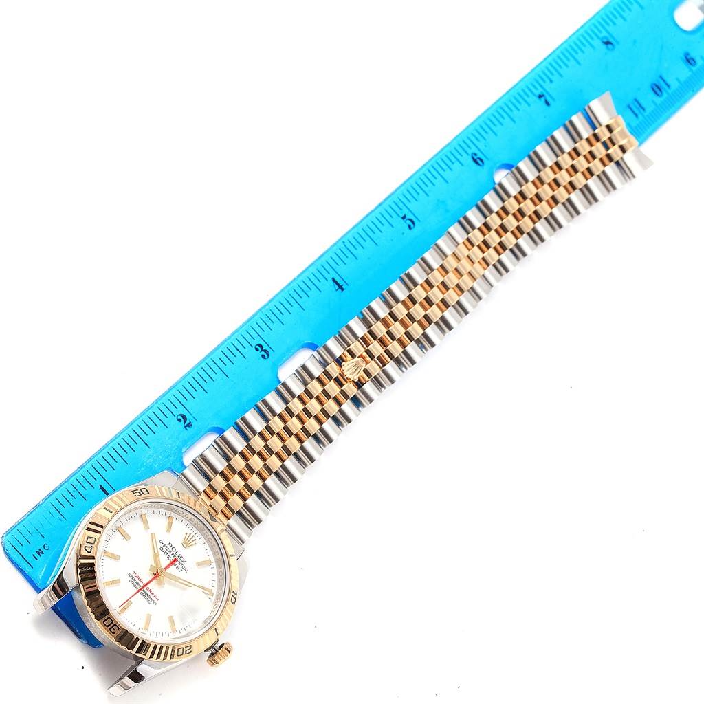 The image shows the entire Rolex Turn-o-Graph 116263 Men
s Stainless Steel White Dial 116263 Men
s Stainless Steel White Dial watch, including the face, bezel, and bracelet, aligned beside a ruler.