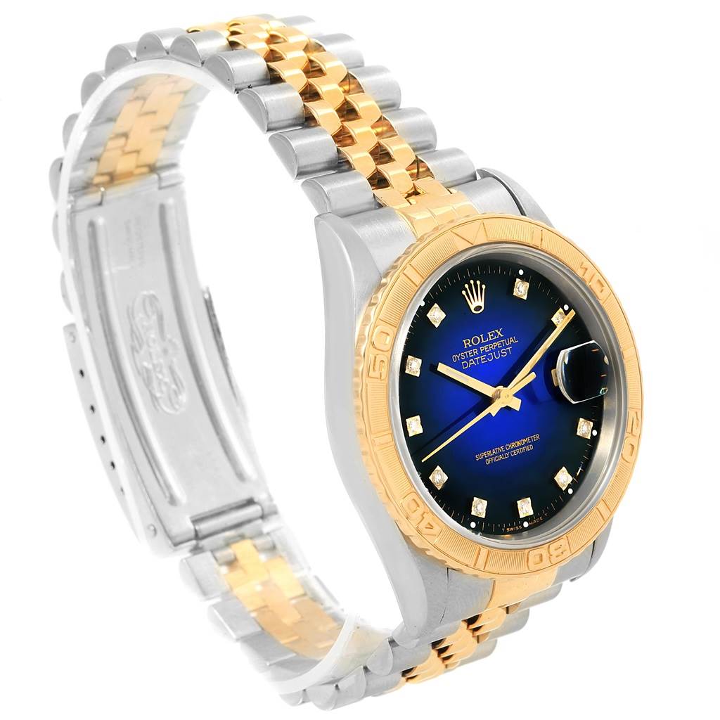 This Rolex Turn-o-Graph 16263 Men
s Steel and Gold (two tone) Blue Dial 16263 Men
s Steel and Gold (two tone) Blue Dial watch is shown from a slight side angle, highlighting its dial, bezel, and bracelet.