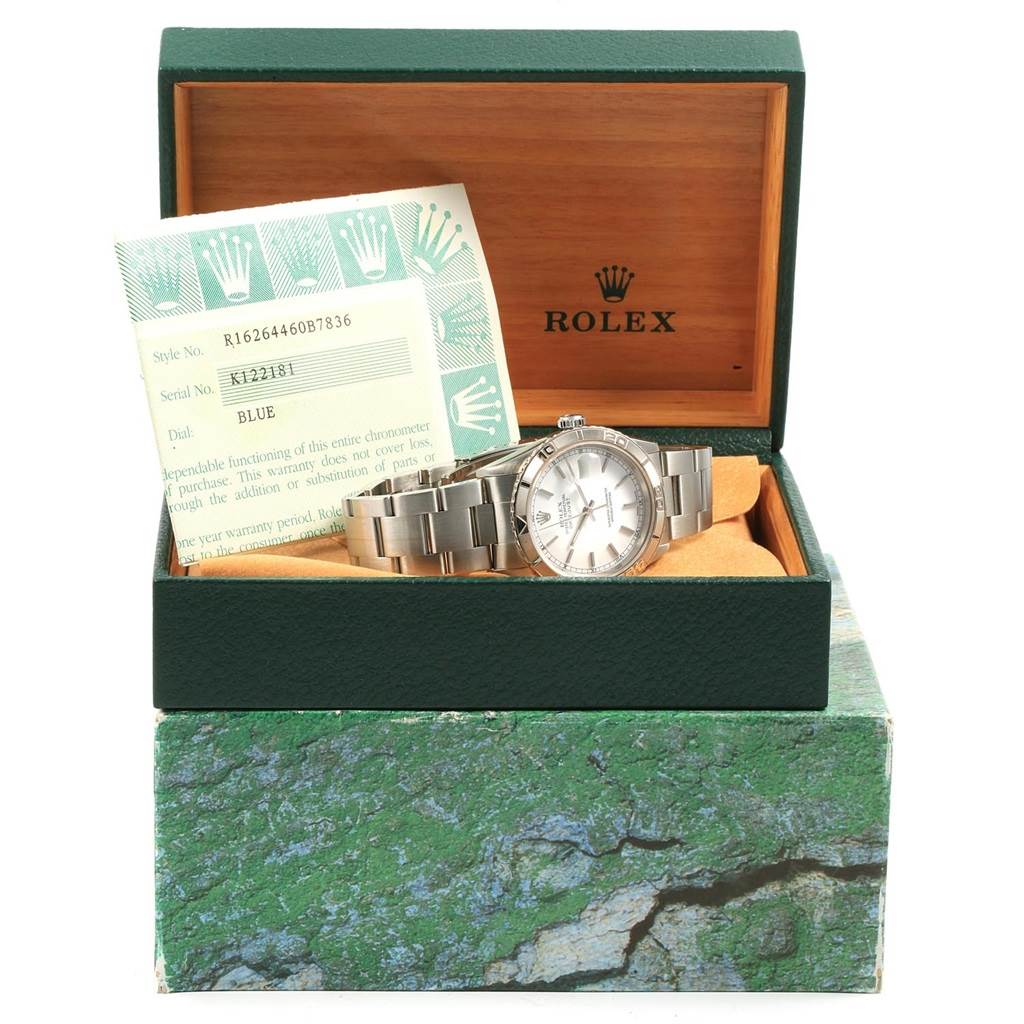 The image shows a Rolex Turn-o-Graph 16264 Men's Stainless Steel White Dial 16264 Men's Stainless Steel White Dial watch in an open box, with warranty papers placed behind the watch.
