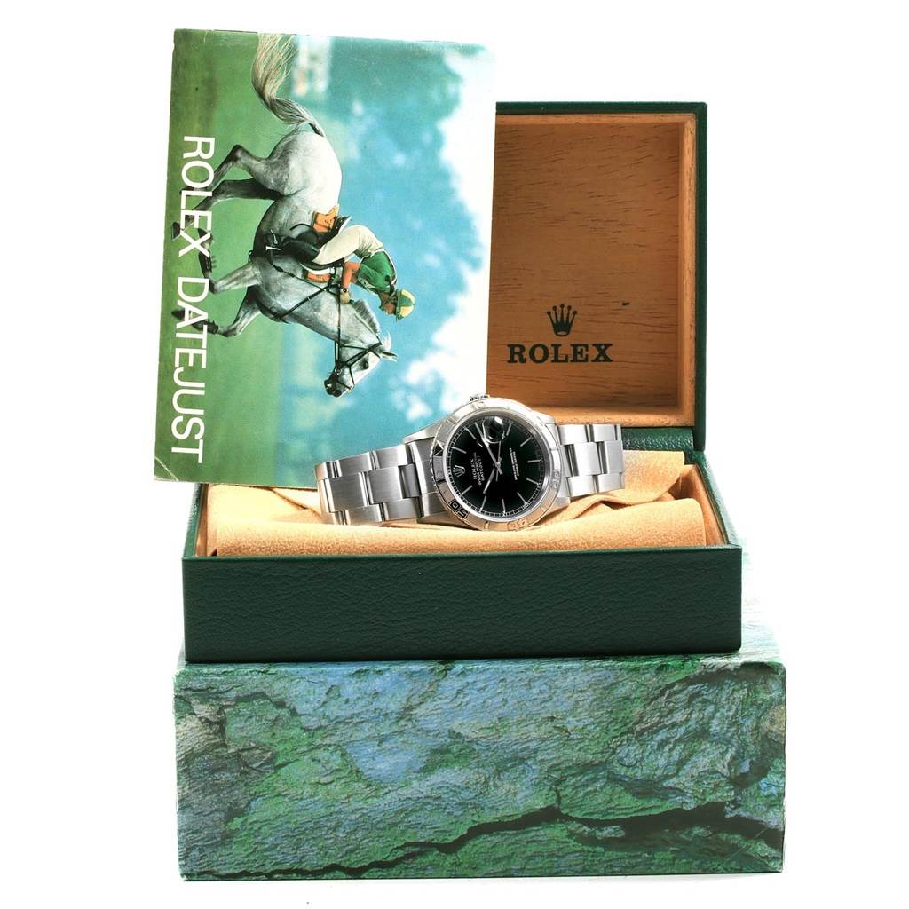 The Rolex Turn-o-Graph 16264 Men's Stainless Steel Black Dial 16264 Men's Stainless Steel Black Dial watch is displayed at a slight angle inside an open watch box with a booklet labeled "Rolex Datejust" beside it.