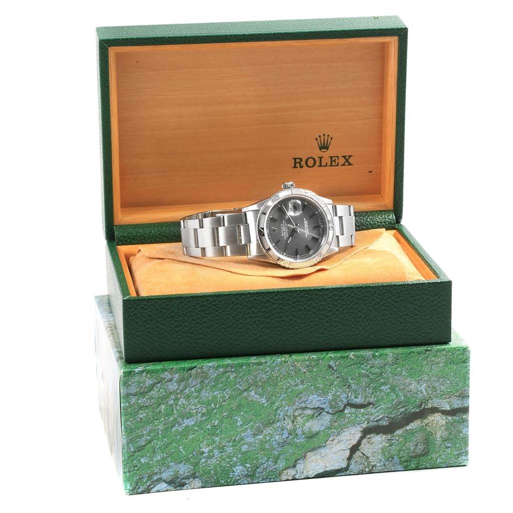 The Rolex Turn-o-Graph 16264 Men's Stainless Steel Grey Dial 16264 Men's Stainless Steel Grey Dial watch is shown front-on, displayed in an open green and gold box on a cushion.