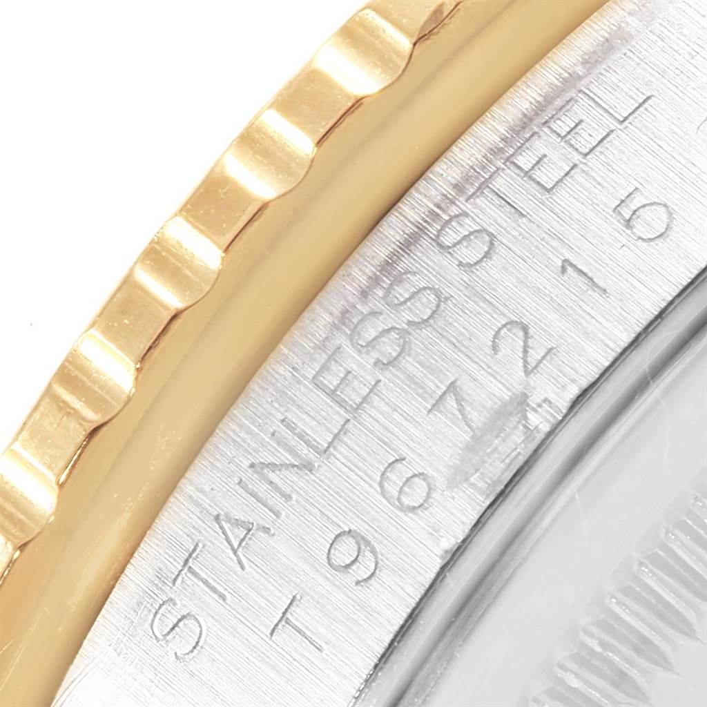 A close-up angle of a Rolex Turn-o-Graph 16263 Men
s Steel and Gold (two tone) Beige Dial 16263 Men
s Steel and Gold (two tone) Beige Dial watch showing part of the bezel and part of the stainless steel case with engraved text.