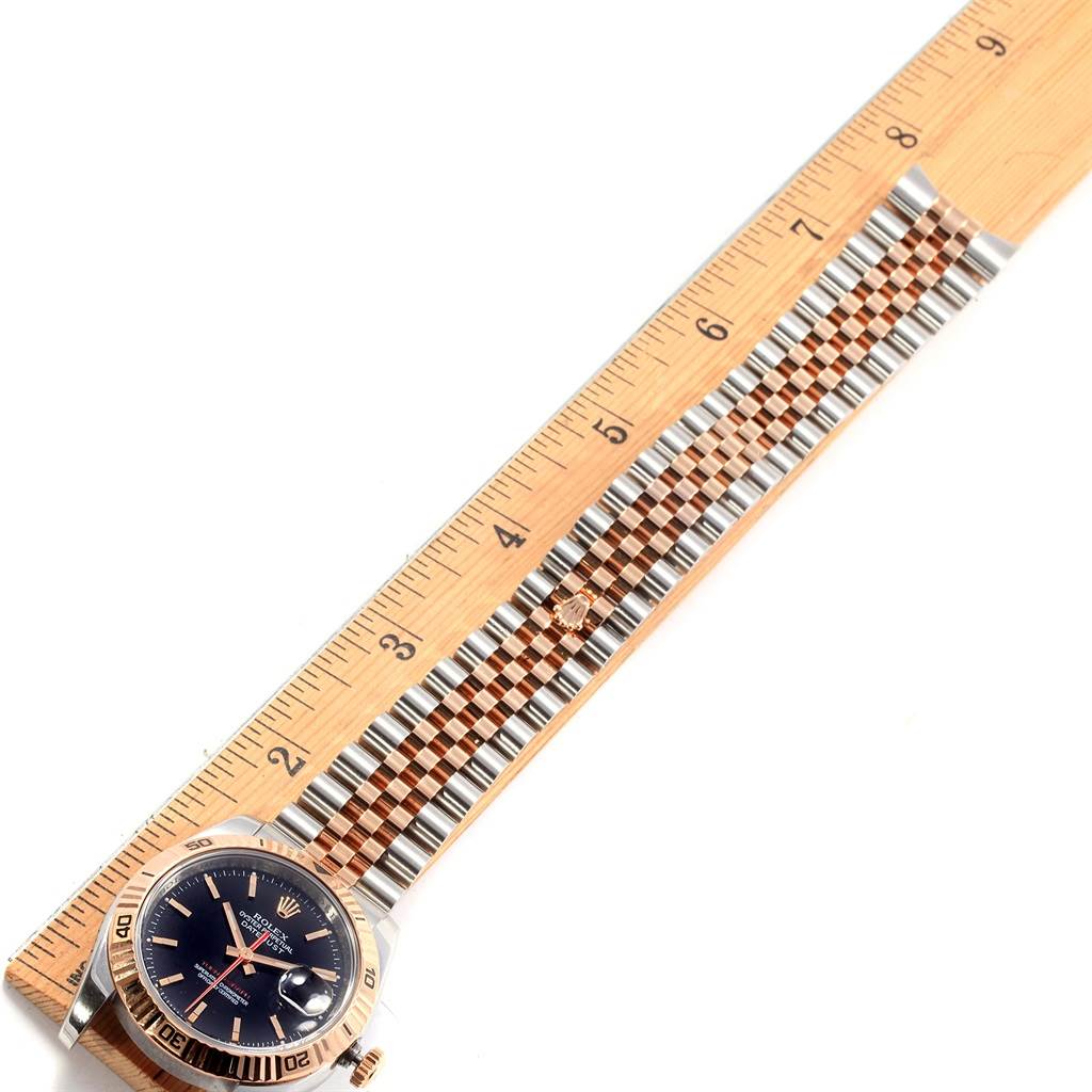 The image shows a Rolex Turn-o-Graph 116261 Men's Stainless Steel Black Dial 116261 Men's Stainless Steel Black Dial watch laid flat next to a ruler, displaying the face, bezel, and bracelet.