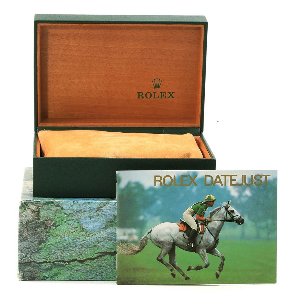 The image shows an open Rolex box with a cushion inside and a brochure labeled "Rolex Datejust" in front.