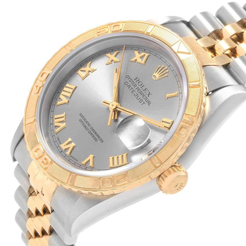 The image shows a close-up of the Rolex Turn-o-Graph 16263 Men's Steel and Gold (two tone) Grey Dial 16263 Men's Steel and Gold (two tone) Grey Dial watch, highlighting its gold bezel, two-tone band, dial, and date magnifier.