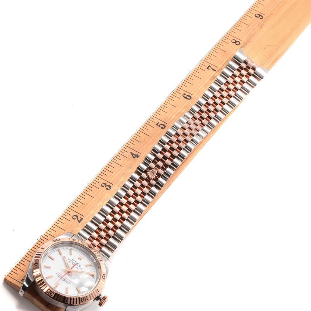 The image shows a Rolex Turn-o-Graph 116261 Men
s Stainless Steel White Dial 116261 Men
s Stainless Steel White Dial watch laid flat with its bracelet aligned next to a ruler for measurement.