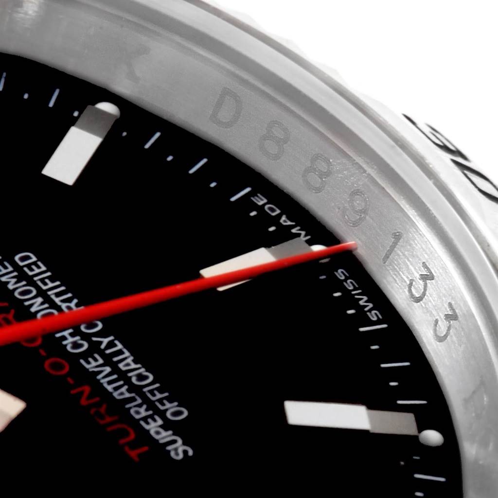 The image shows a close-up angle of the dial and bezel of a Rolex Turn-o-Graph 116264 Men
s Stainless Steel Black Dial 116264 Men
s Stainless Steel Black Dial watch, displaying the red second hand and part of the engraving.