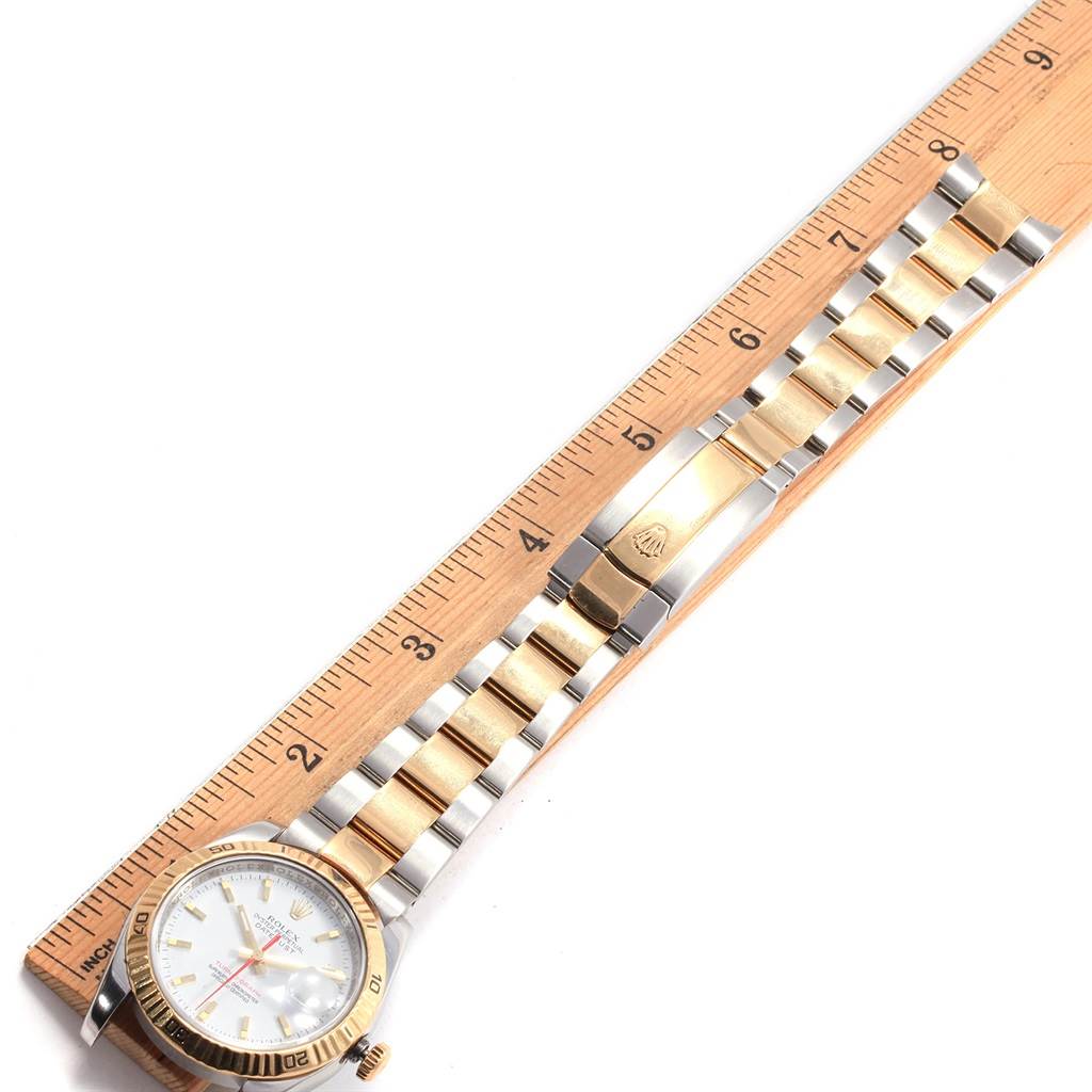 The Rolex Turn-o-Graph 116263 Men's Stainless Steel White Dial 116263 Men's Stainless Steel White Dial watch is shown from a top-down angle, displaying the watch face and the full length of the bracelet with a ruler beside it.