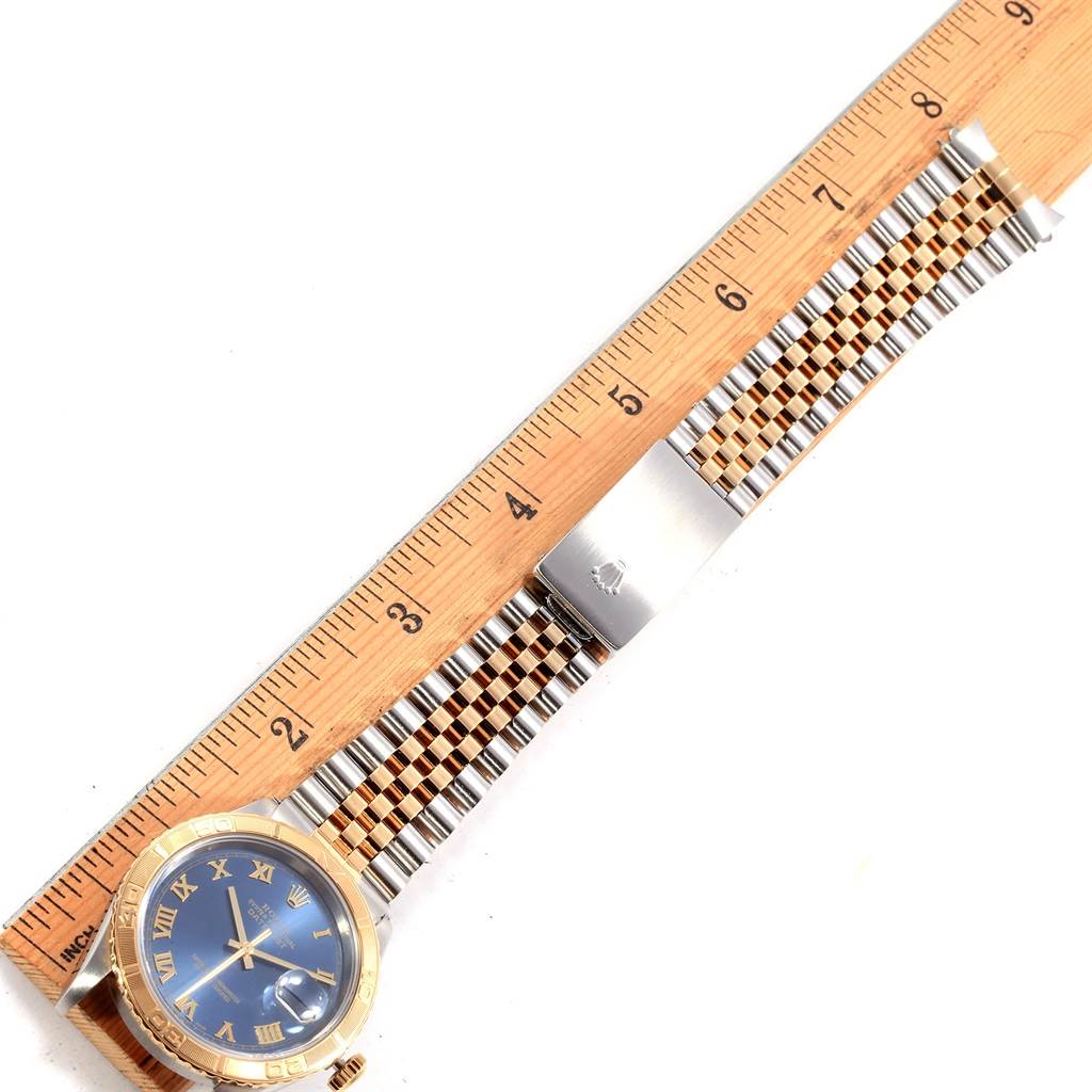 The image shows a Rolex Turn-o-Graph 16263 Men's Steel and Gold (two tone) Blue Dial 16263 Men's Steel and Gold (two tone) Blue Dial watch laid flat with a wooden ruler indicating its length.