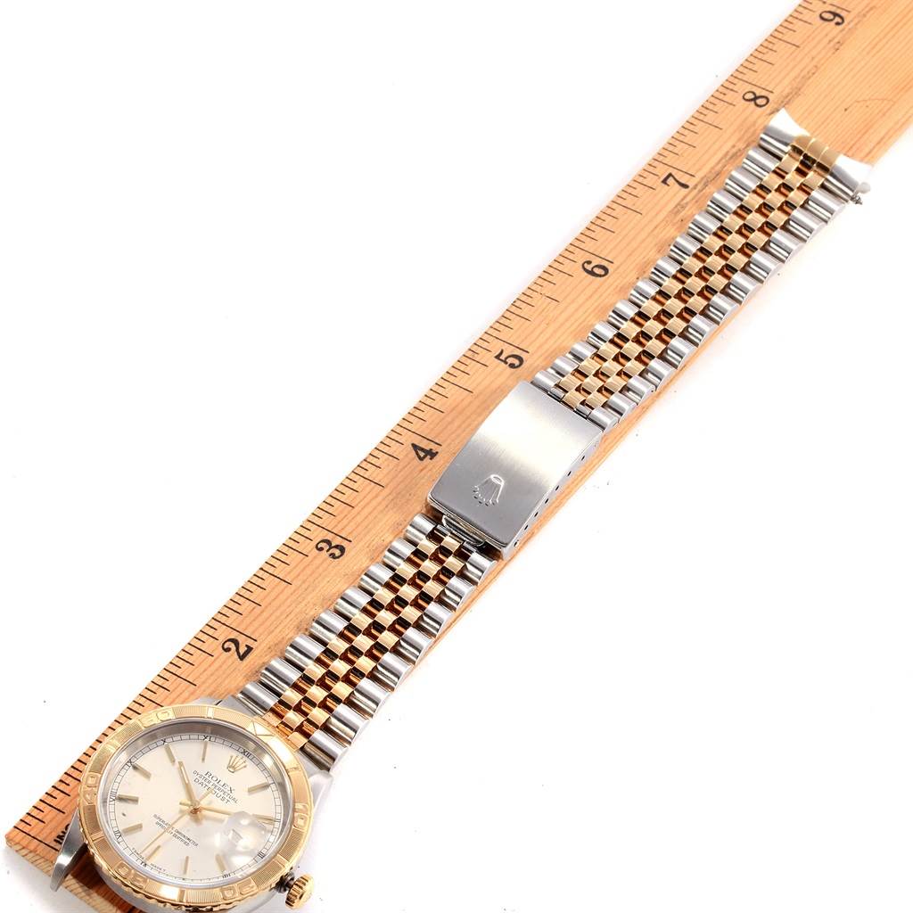 The image shows a top view of a Rolex Turn-o-Graph 16263 Men's Steel and Gold (two tone) Silver Dial 16263 Men's Steel and Gold (two tone) Silver Dial watch, featuring its bezel, dial, and stainless steel and gold bracelet.